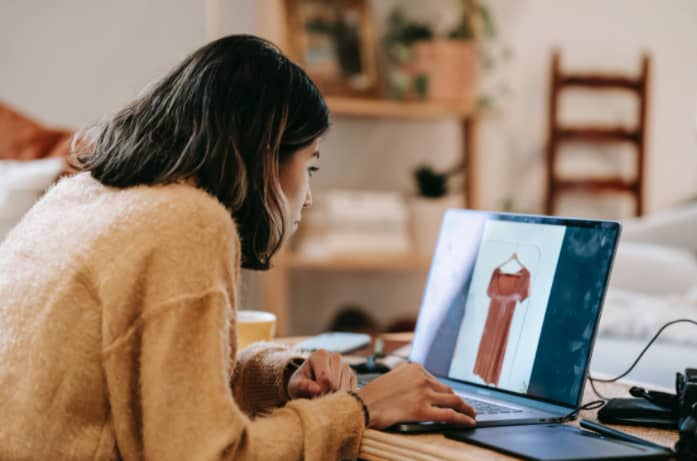 ethnic freelancer working on laptop with photo